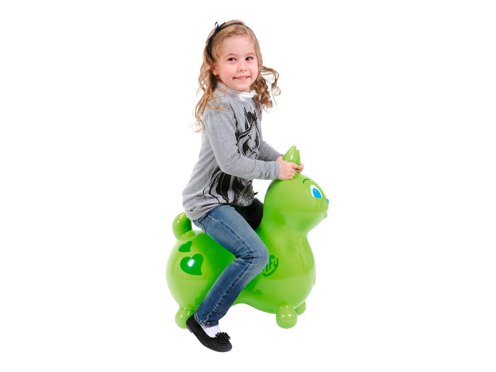 Un enfant assis sur un lapin sauteur vert. L'enfant porte un jean et un haut gris.