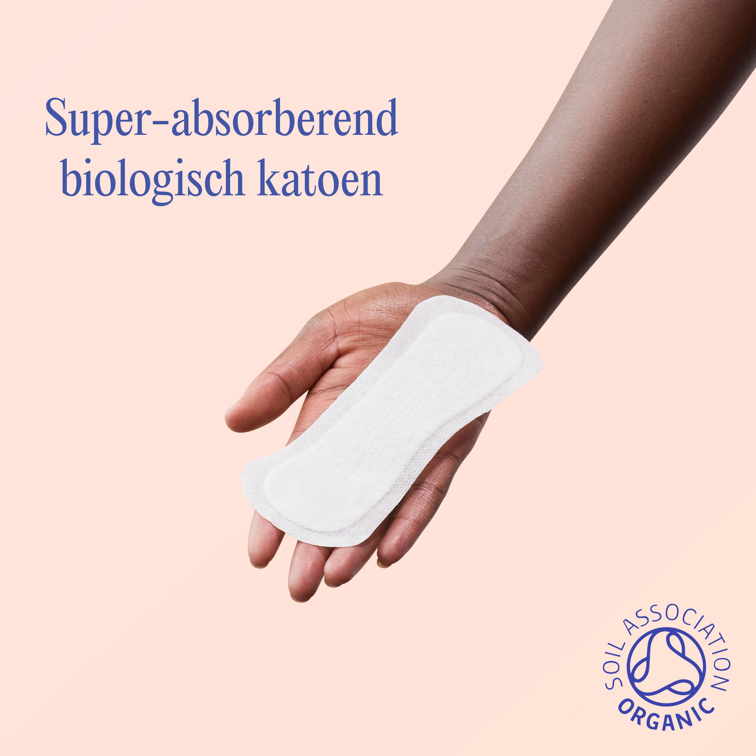 Hand die een witte inlegkruisje vasthoudt. Op roze achtergrond.