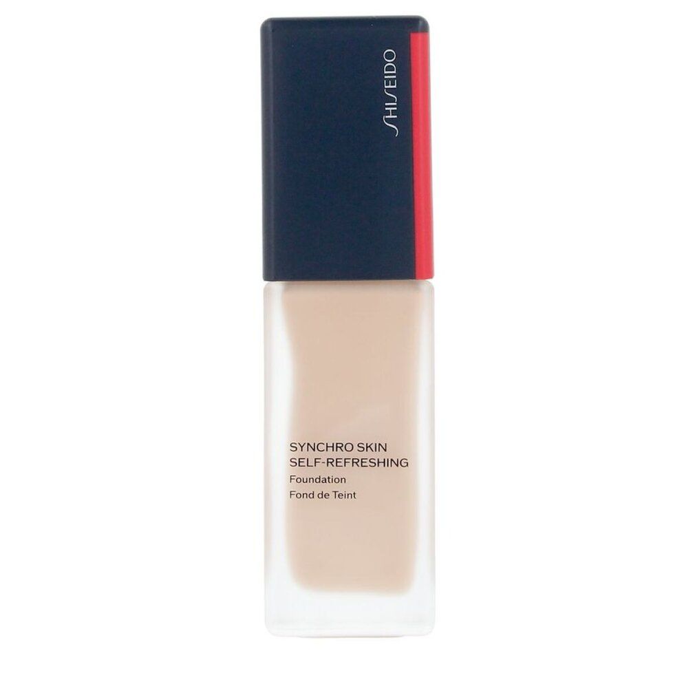 Flacon de fond de teint beige. Bouchon bleu foncé avec bande rouge. Inscription: Shiseido, Synchro Skin Self-Refreshing Foundation.