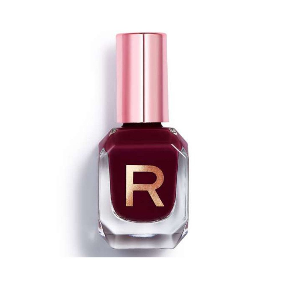 Fles donkerrode nagellak met roségouden dop. Transparante glazen fles met gouden 'R'-opdruk.