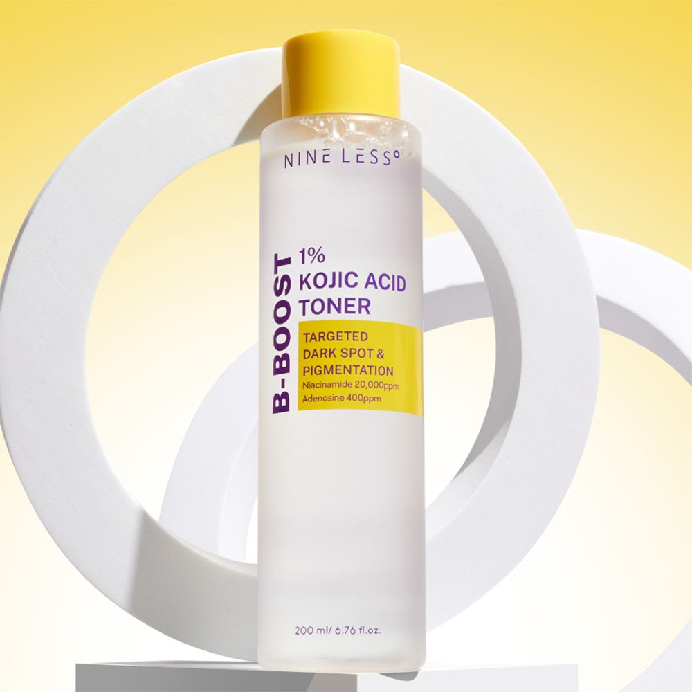 Flacon de toner transparent avec bouchon jaune. Inscription: NINE LESS, B-Boost, 1% Kojic Acid Toner.