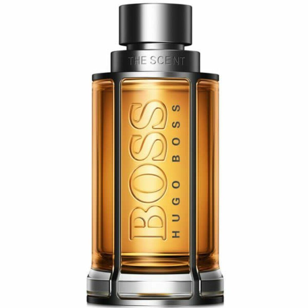 Gouden parfumfles met zilveren dop. Opschriften BOSS en HUGO BOSS. THE SCENT.