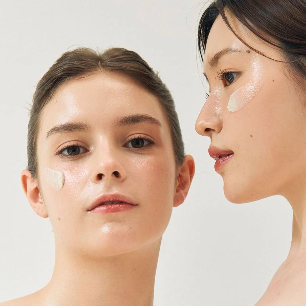 Twee vrouwen met de BEAUTY OF JOSEON Ground Rice and Honey Glow Mask op hun wangen.