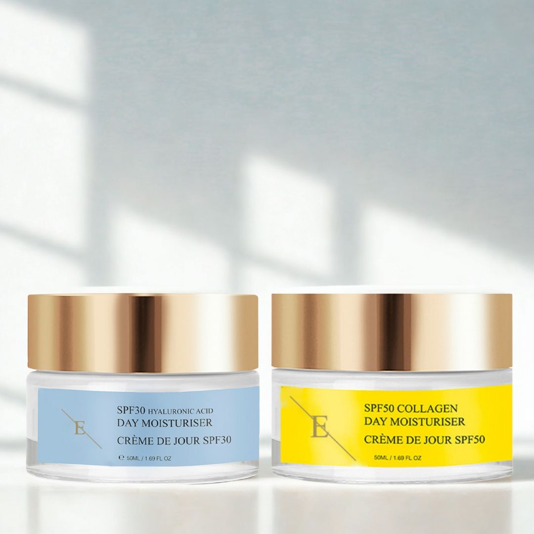 Twee crèmes met gouden deksels en etiketten. "SPF30" en "SPF50". De crèmes staan naast elkaar.