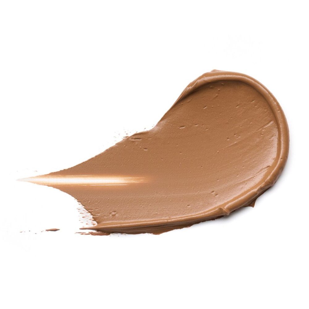 Nuance de fond de teint sur fond blanc. Nuance en forme de trait. Couleur et texture du produit visibles.