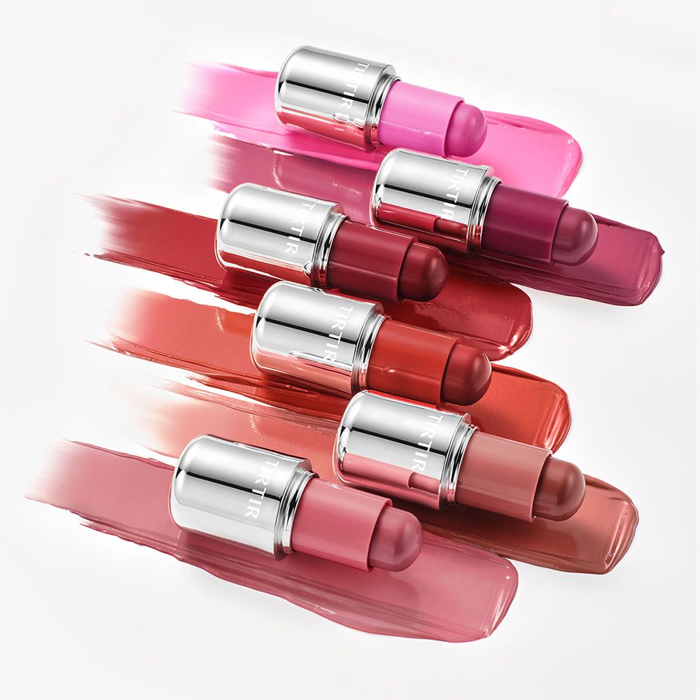 Meerdere TIRTIR Mood Glider sticks in diverse kleuren op kleurstrepen.