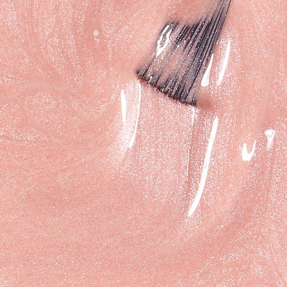 Nagellak-applicator in roze lak. Kwastje met lak. Close-up.