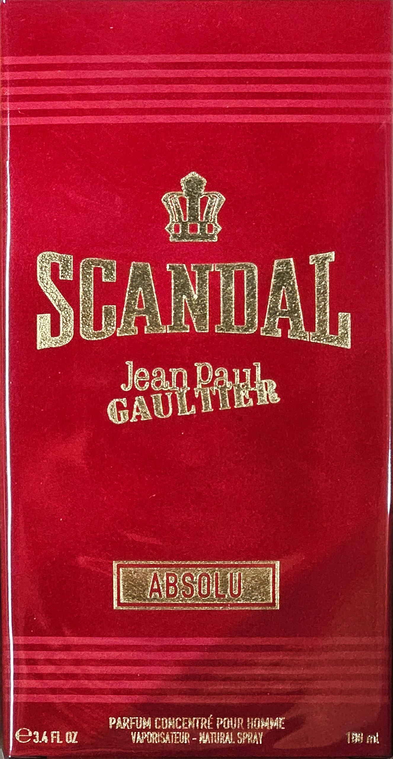 Boîte rouge avec texte doré "SCANDAL" et couronne. "Jean Paul Gaultier" en dessous. Label "Absolu".