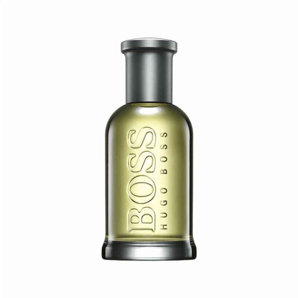Flacon Boss Bottled Eau de Toilette. Flacon en verre avec bouchon argenté. Logo et nom du produit visibles.