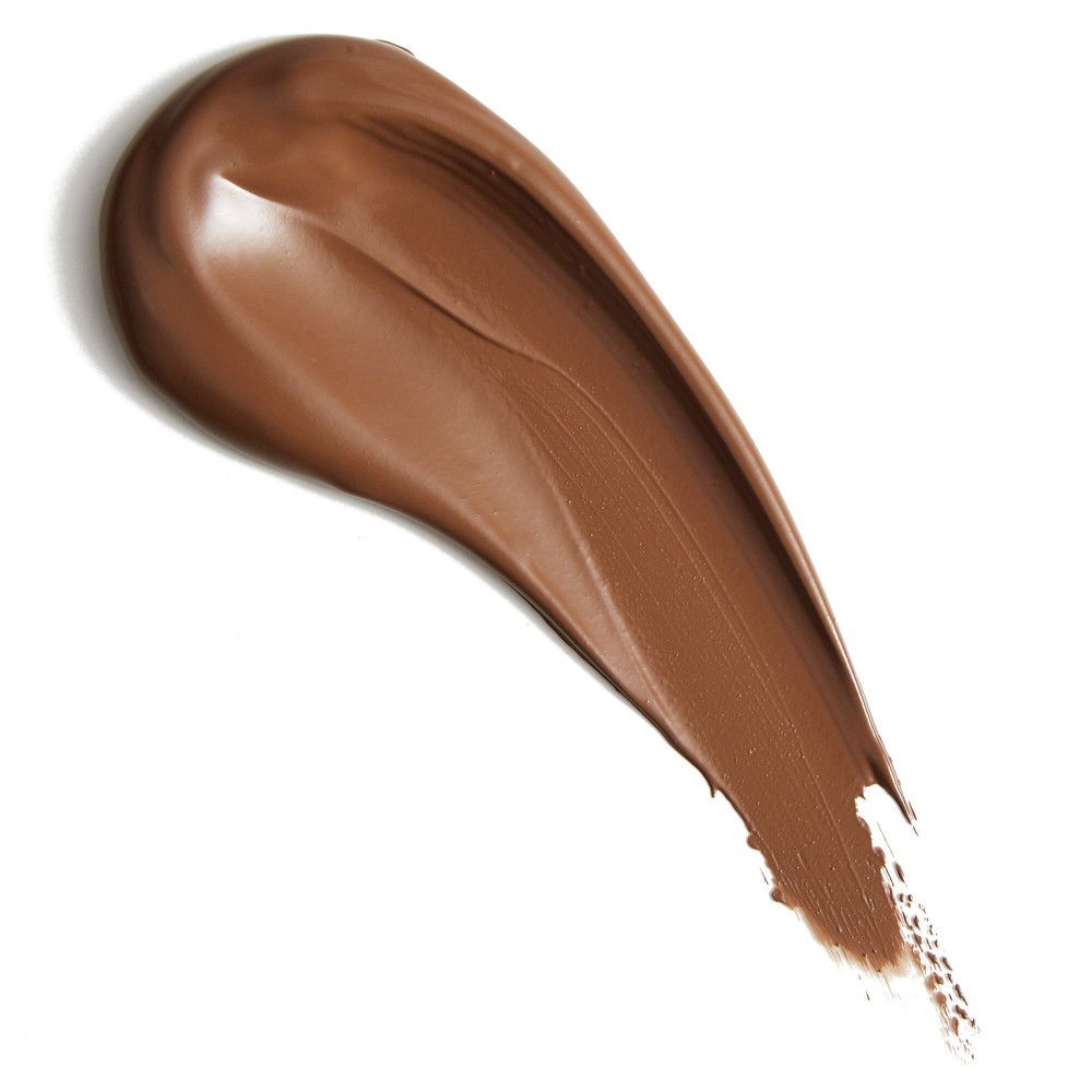 Trace de correcteur brun sur fond blanc. Texture visible.