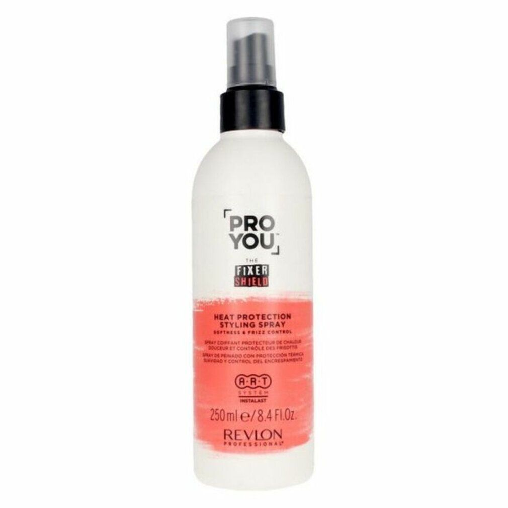 Flacon spray blanc et rouge. Inscription: PRO YOU THE FIXER SHIELD, Heat Protection Styling Spray, Revlon Professional. Tête de pulvérisation noire.