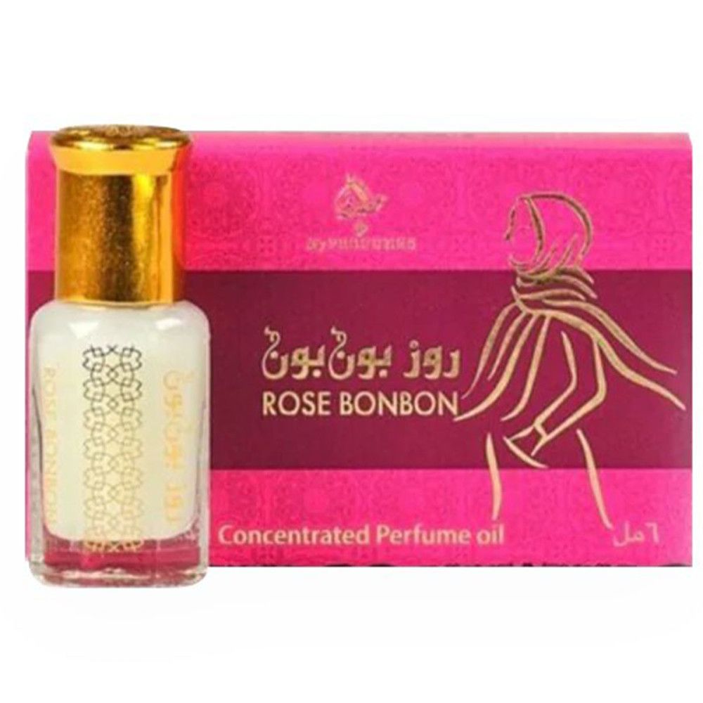 Flacon de parfum concentré avec bouchon doré, à côté d'un emballage rose avec texte arabe et silhouette féminine.