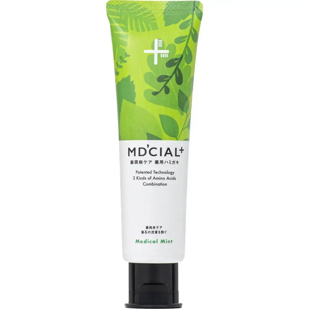 Tube de dentifrice MD'CIAL+ vert. Inscription Medical Mint. Bouchon noir. Motif de feuilles.