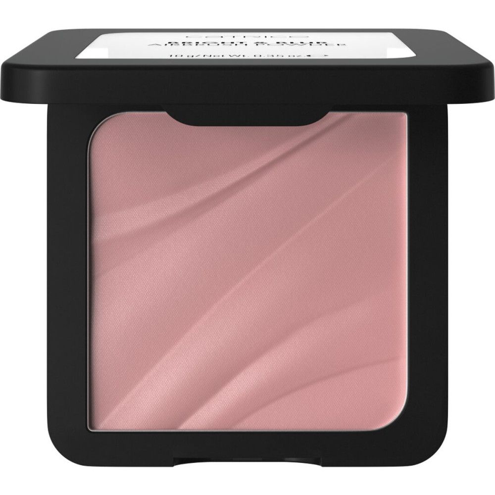 Poudre compacte dans un emballage noir. Poudre rose avec motif ondulé. Marque Catrice.