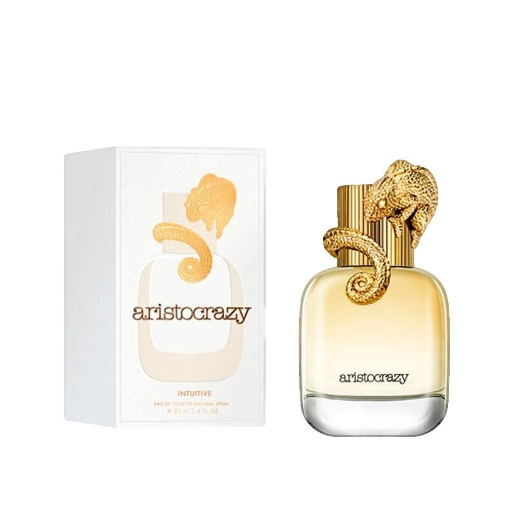 Flacon de parfum avec bouchon doré en forme de reptile. Emballage blanc avec logo et texte du produit.