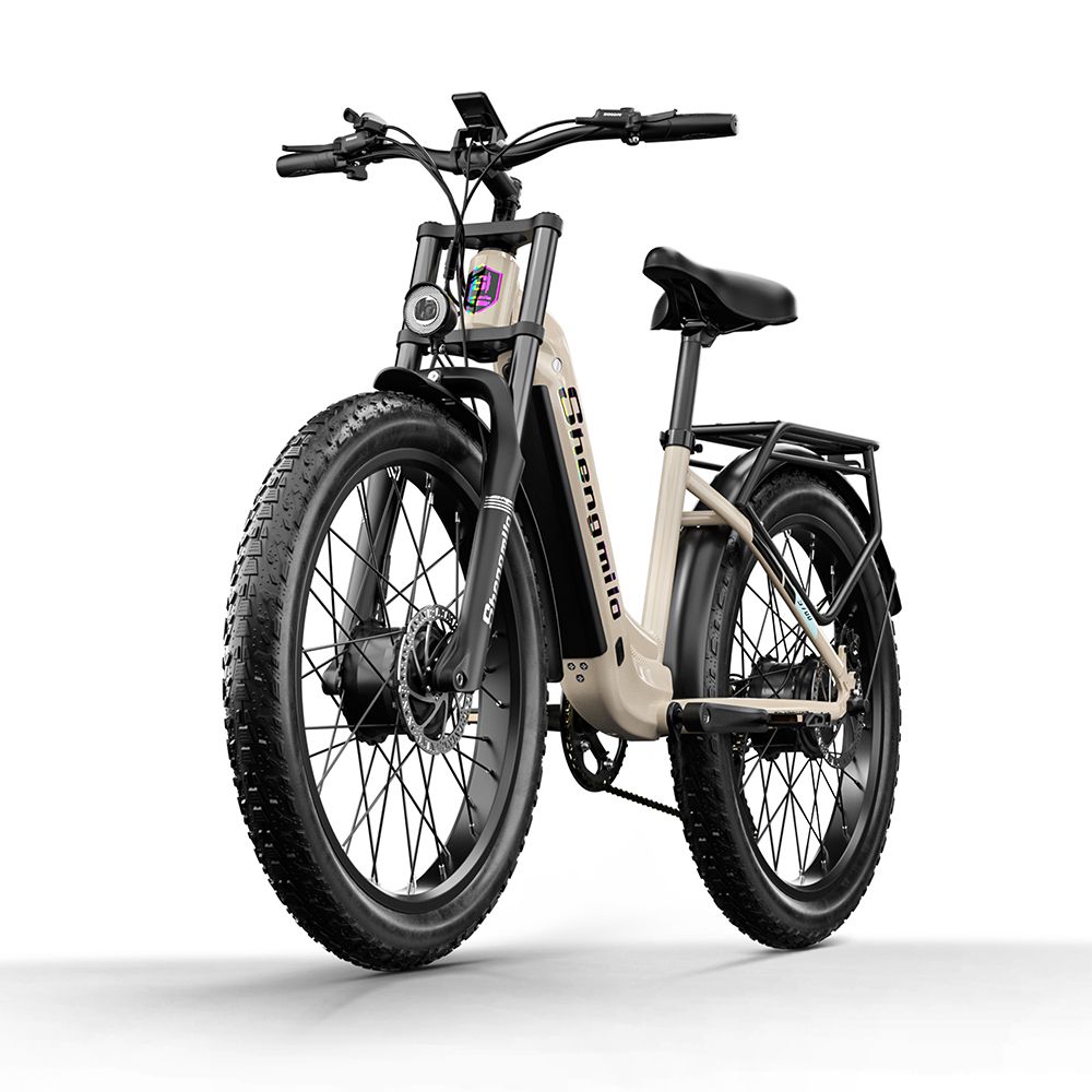 E-bike, vue de face. Cadre beige, pneus noirs. Marque Shengmilo visible. Phare avant et suspension.