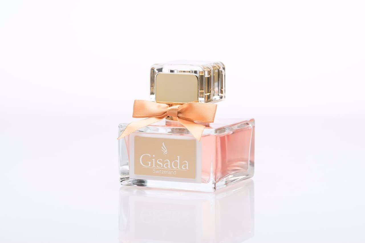 Rechthoekige glazen fles met roze parfum, gouden dop en oranje strik.