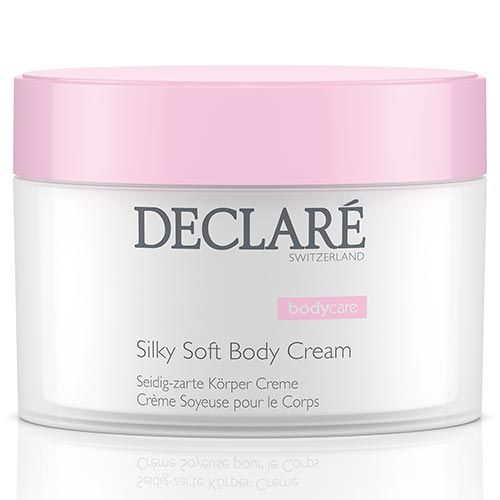 Pot de crème avec couvercle rose. Inscription: DECLARÉ SWITZERLAND, Silky Soft Body Cream. Texte en allemand et français.