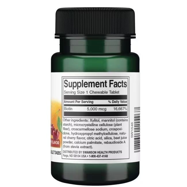 Achterkant groene fles. Etiket met voedingswaarde voor "Biotin" en ingrediëntenlijst. Zwarte dop.