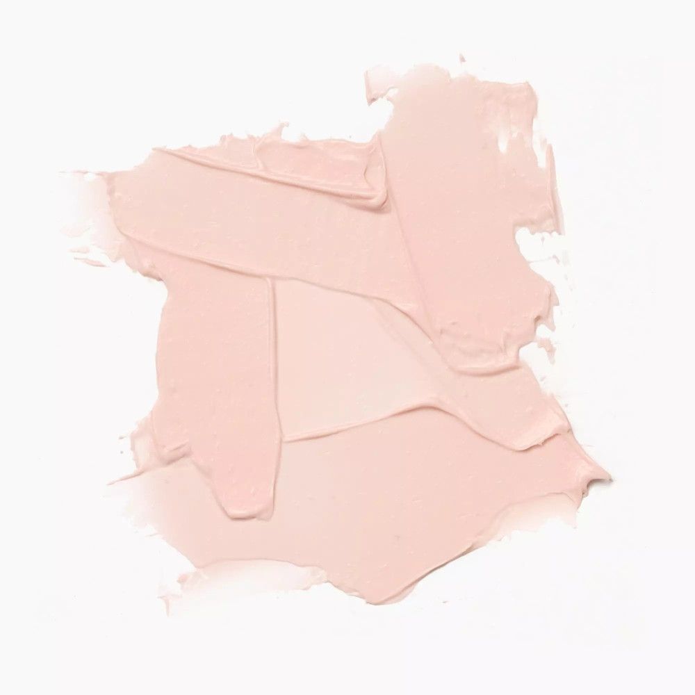 Échantillon de baume à lèvres rose clair sur fond blanc. Texture avec coups de pinceau visibles.