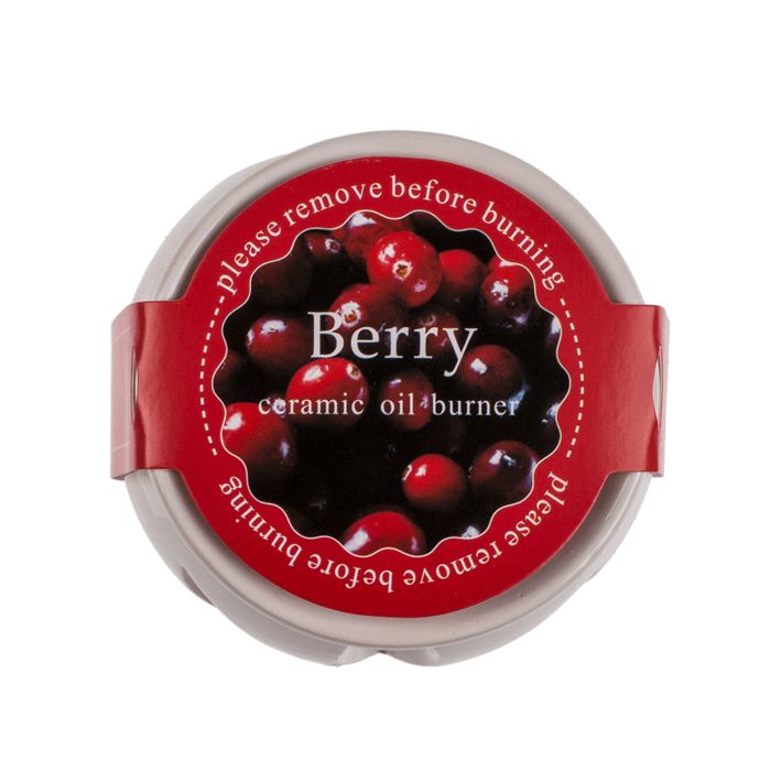 Ronde geurmelt-container met rood etiket. Opschrift 'Berry' en 'ceramic oil burner'. 'Verwijder voor het branden'.