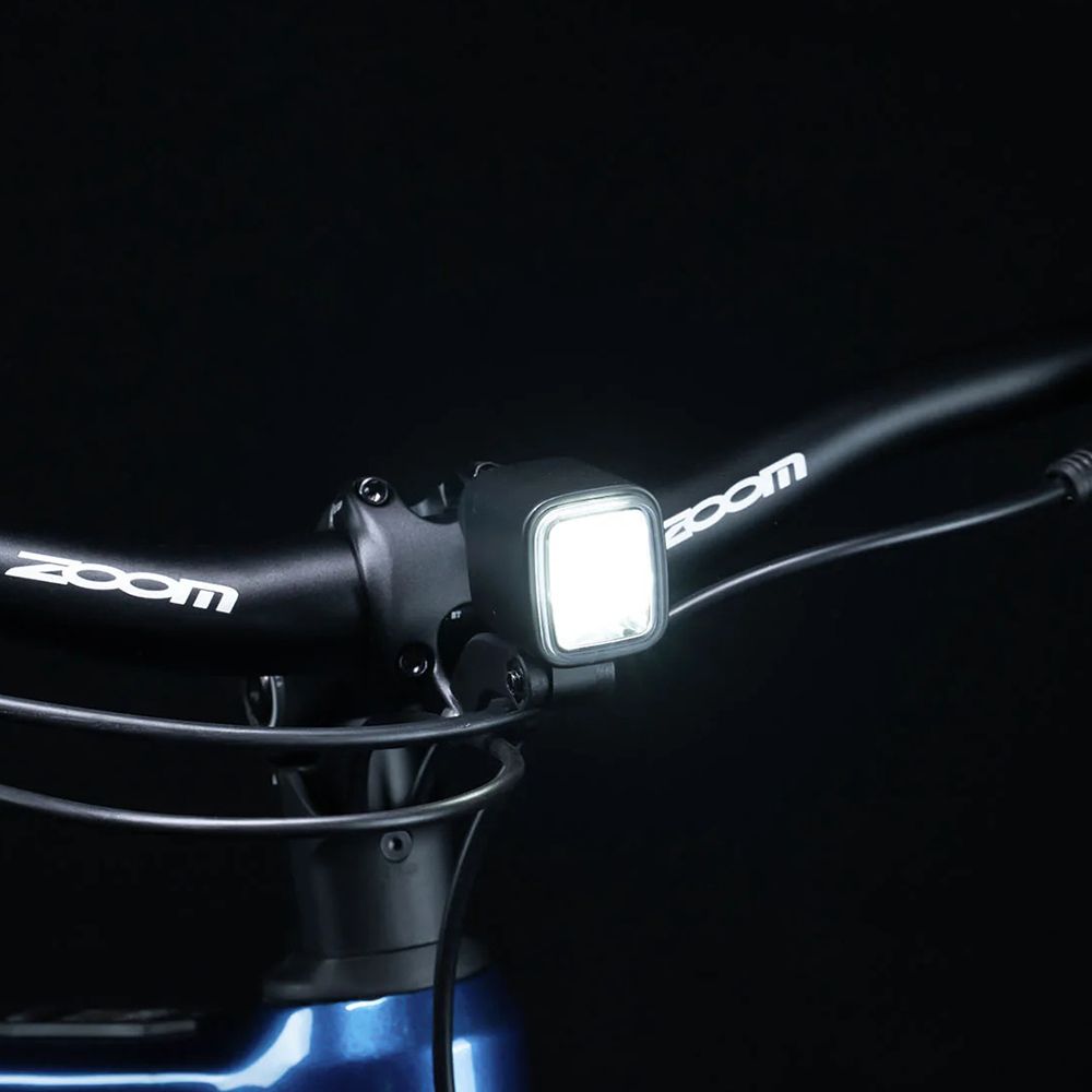 Fietsstuur met koplamp. Koplamp met wit licht, stuur met Zoom-logo.