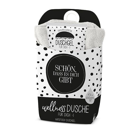 Coffret cadeau de douche avec serviette et gel douche. Emballage noir à pois blancs et texte : "Schön, dass es dich gibt".