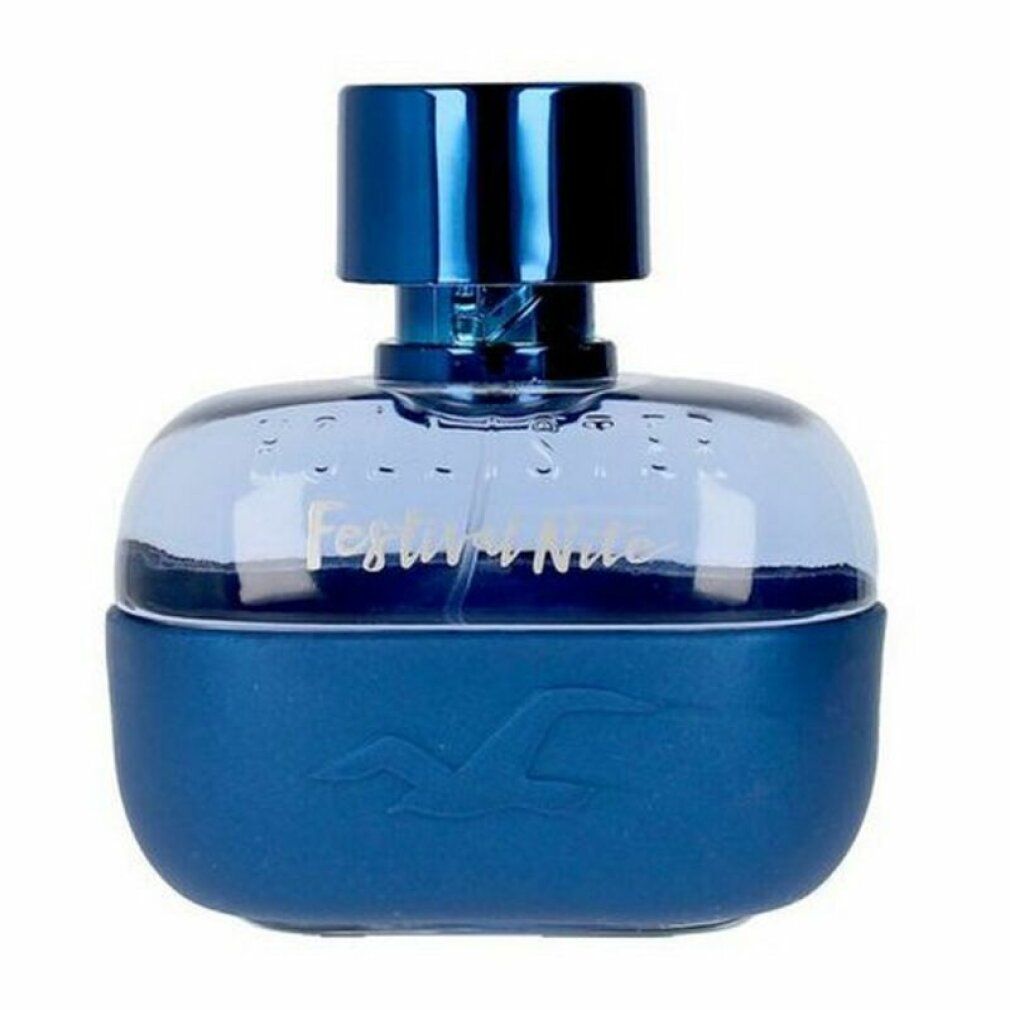 Flacon de parfum bleu. Le flacon indique "Festival Nite". Le flacon est de forme ronde et a un bouchon bleu.