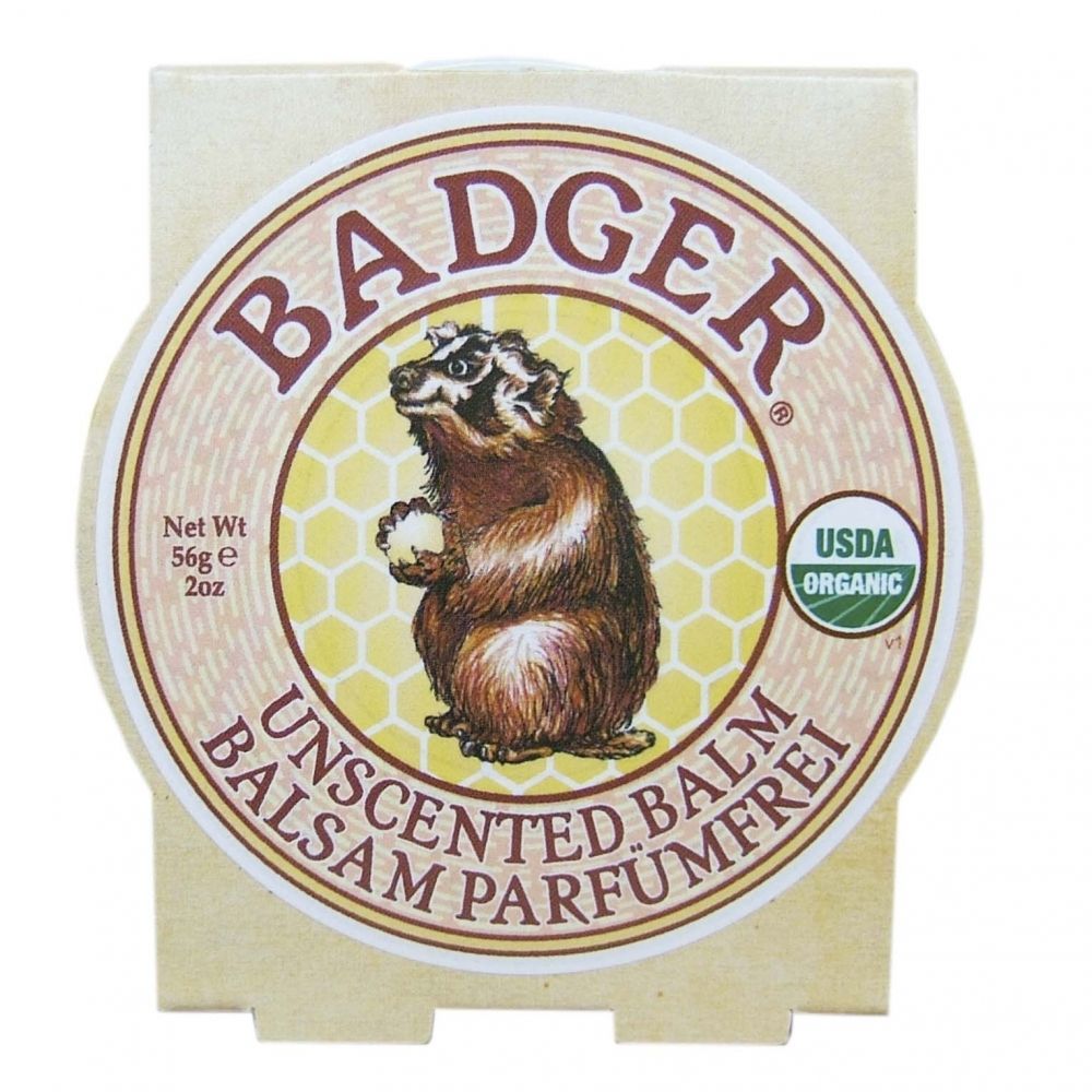 Ronde pot met etiket. Opschrift: BADGER, UNSCENTED BALM, BALSAM PARFUMFREI. USDA Organic zegel. Illustratie van een das.