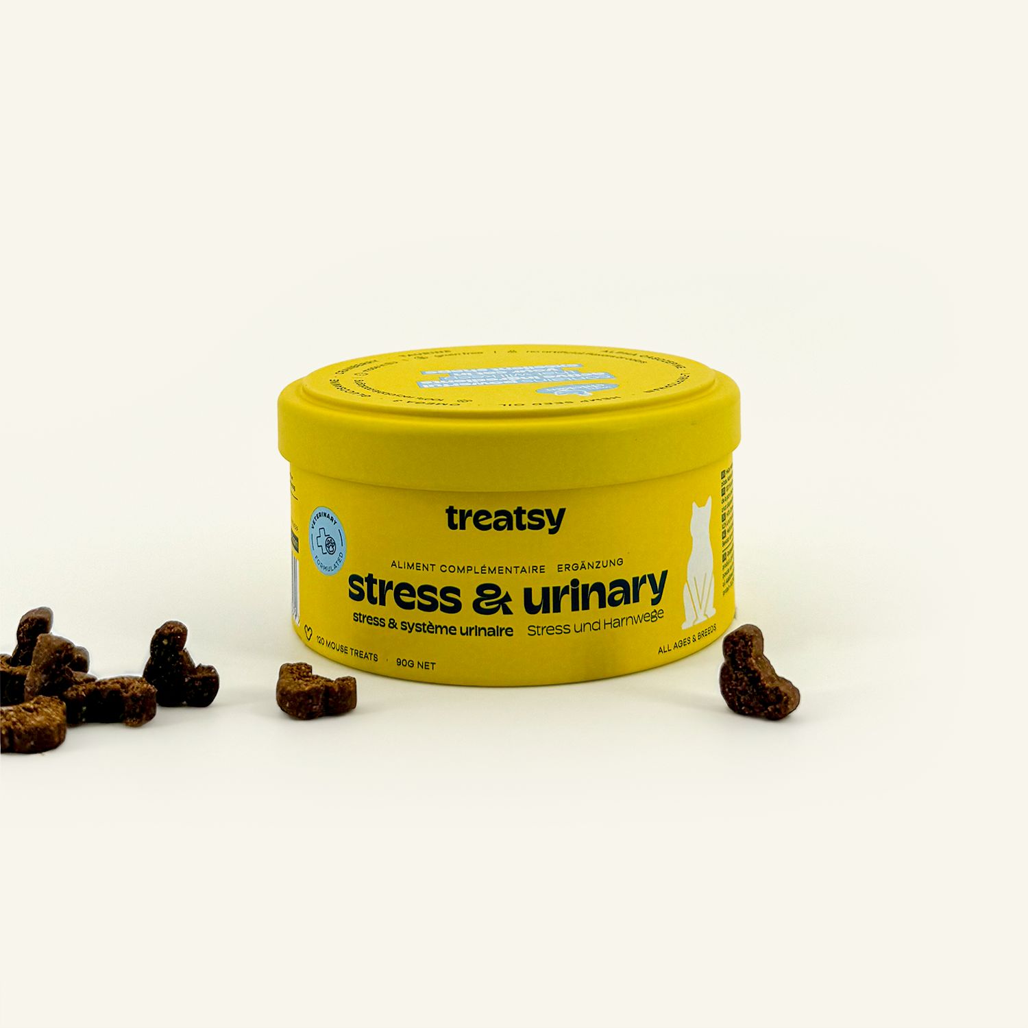 Boîte jaune « Treatsy Stress & Urinary ». Friandises marron à côté.