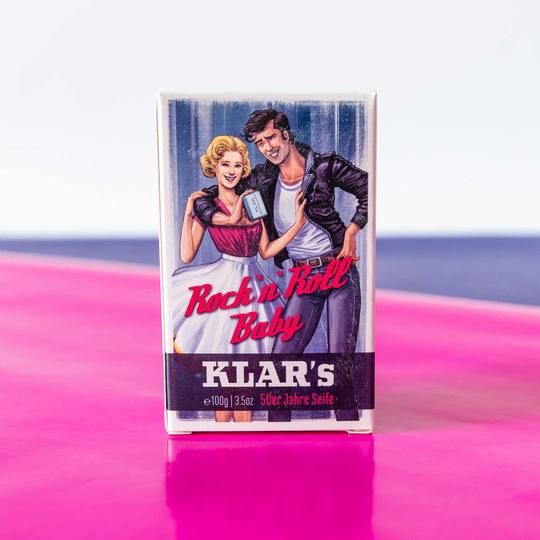 Zeep in retroverpakking. Opdruk: Rock 'n' Roll Baby, Klar's, 50er Jahre Seife. Achtergrond: roze en blauw.