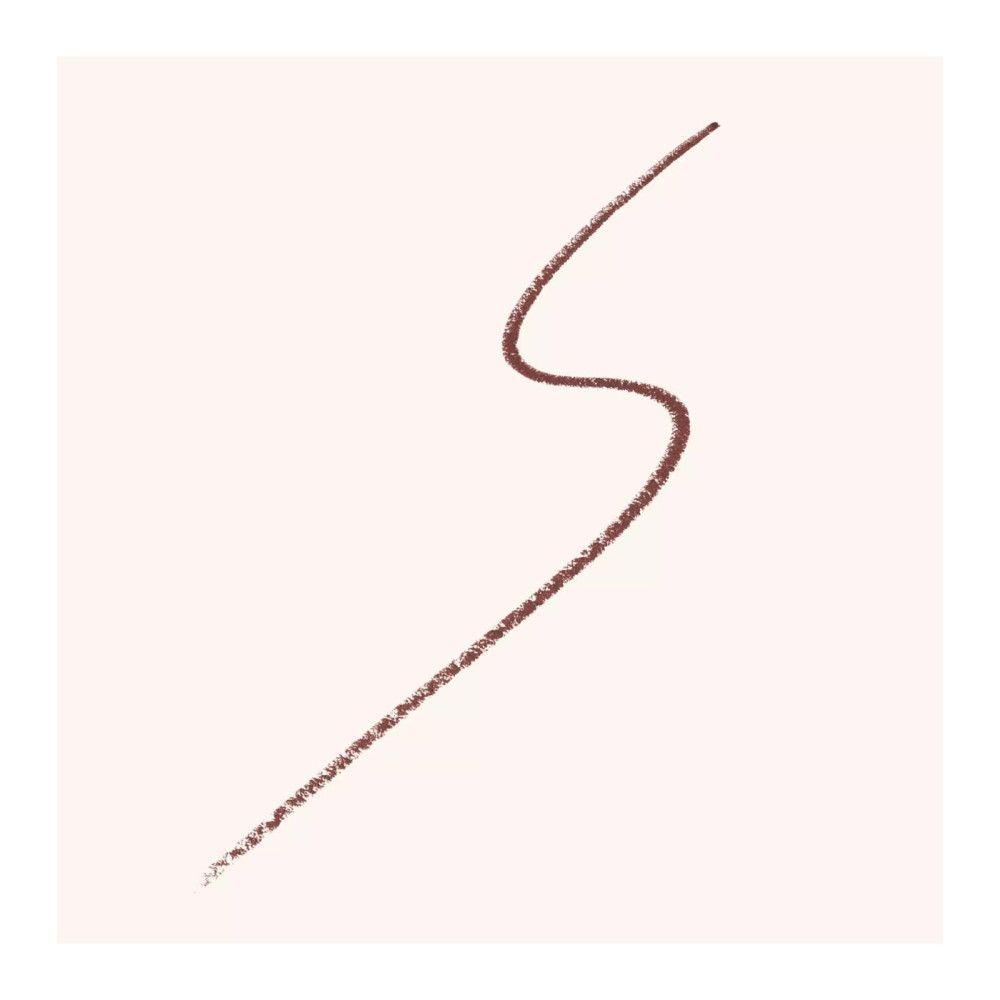 Trait de crayon Kajal brun sur fond clair. Le trait est ondulé.