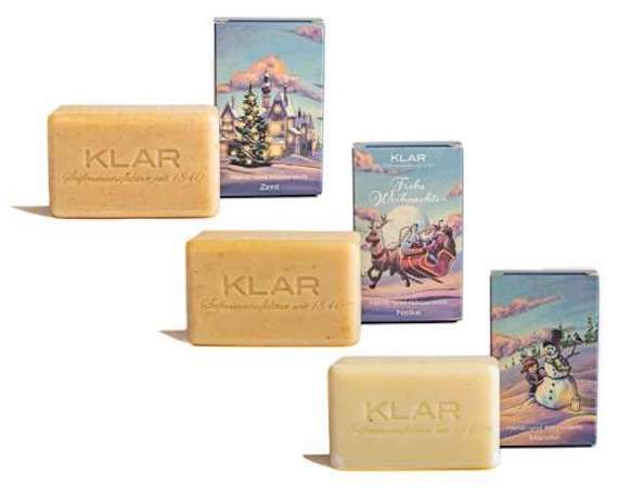 Drie blokken zeep met "KLAR" logo en drie dozen met kerstmotieven. Verschillende motieven en teksten.