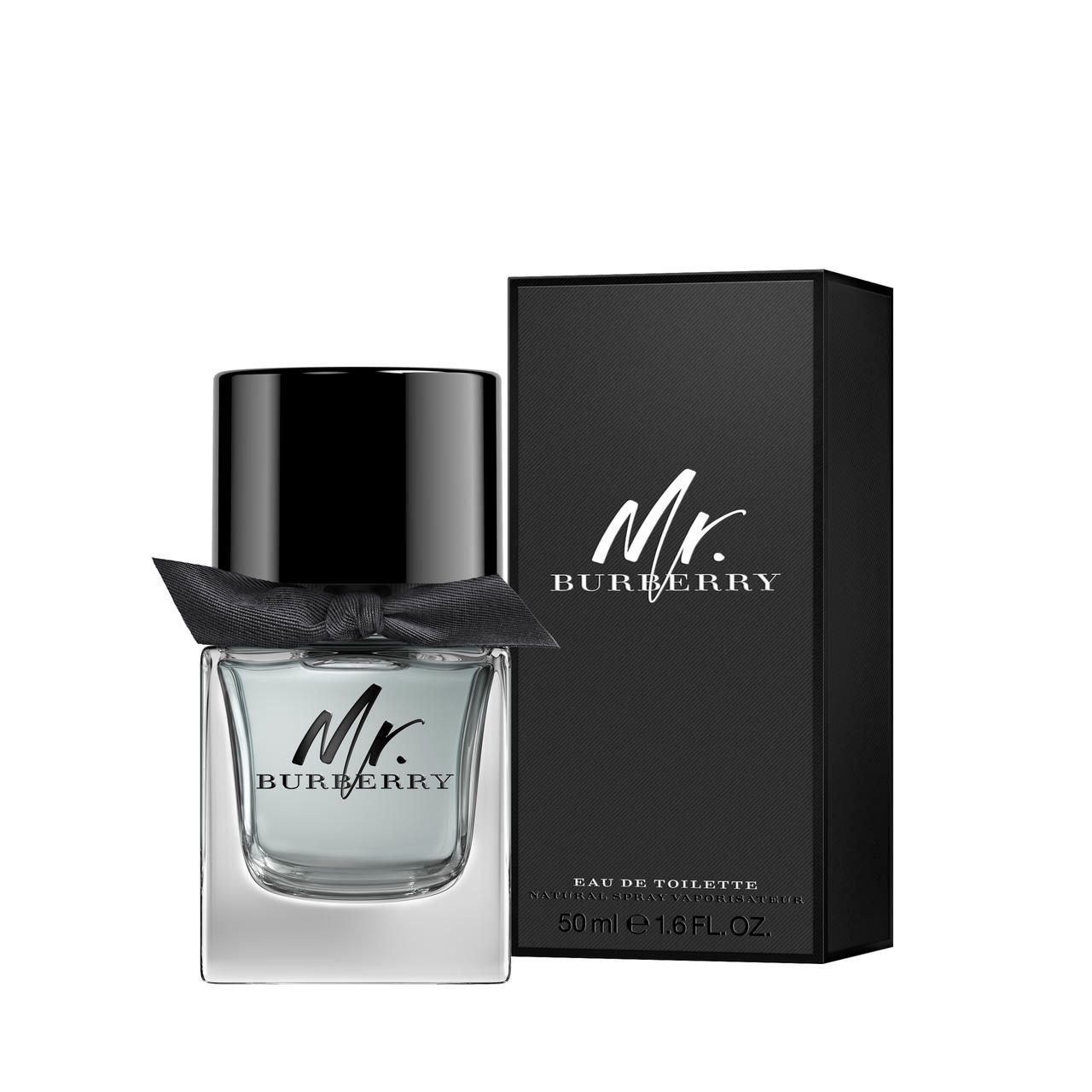 Flacon noir avec bouchon noir et nœud. Boîte noire avec inscription "Mr. Burberry". Texte : Eau de Toilette.