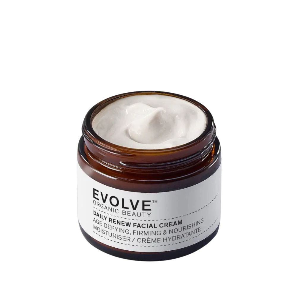 Pot en verre brun contenant une crème blanche. L'étiquette indique "EVOLVE ORGANIC BEAUTY DAILY RENEW FACIAL CREAM".