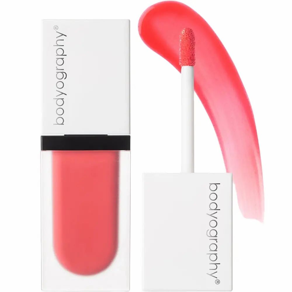 Vloeibare blush met applicator. Merk BODYOGRAPHY. Koraalroze tint. Witte dop, transparante houder.