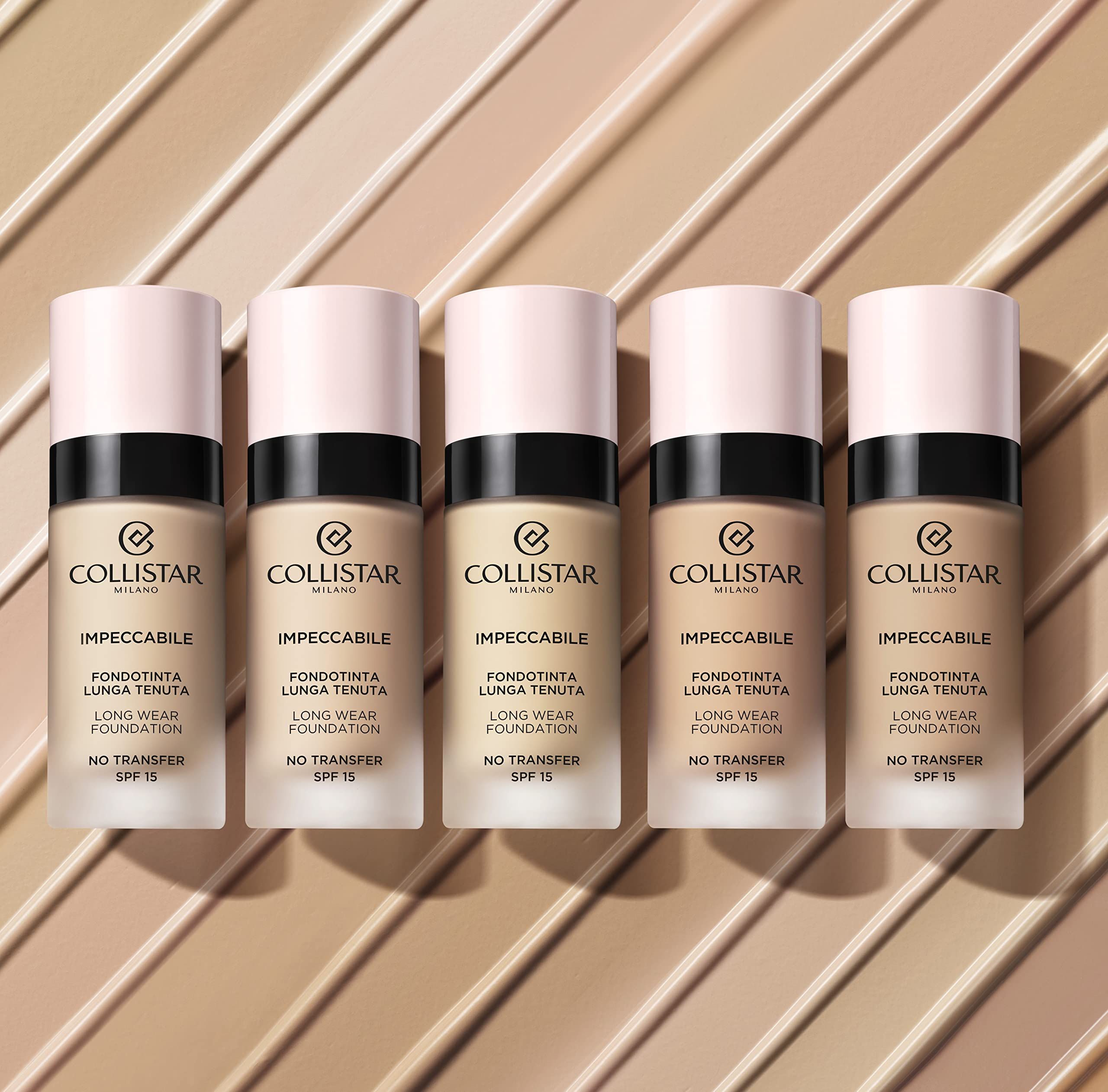 Vijf foundation flesjes naast elkaar. Roze dop, zwarte ring, opschrift. "Collistar Milano", "Impeccabile", "Long Wear Foundation". SPF 15.
