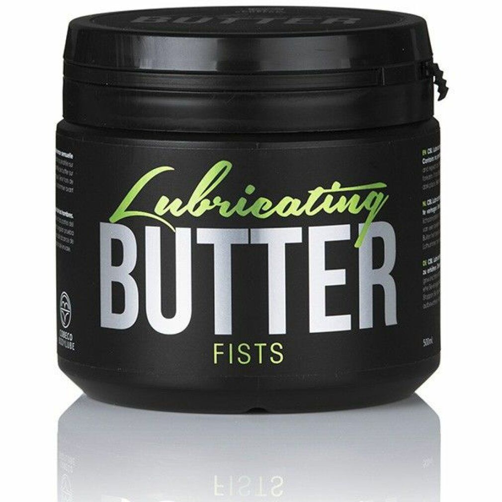 Zwarte pot met deksel. Opschrift: Lubricating BUTTER, FISTS. Groene en zilveren letters. Reflecterend oppervlak.