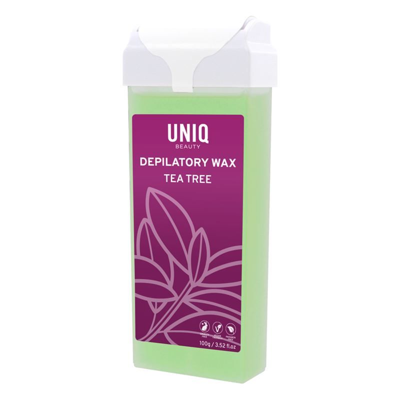 Cartouche de cire verte avec couvercle blanc. Inscription: UNIQ BEAUTY, Depilatory Wax Tea Tree. Étiquette violette avec feuilles.