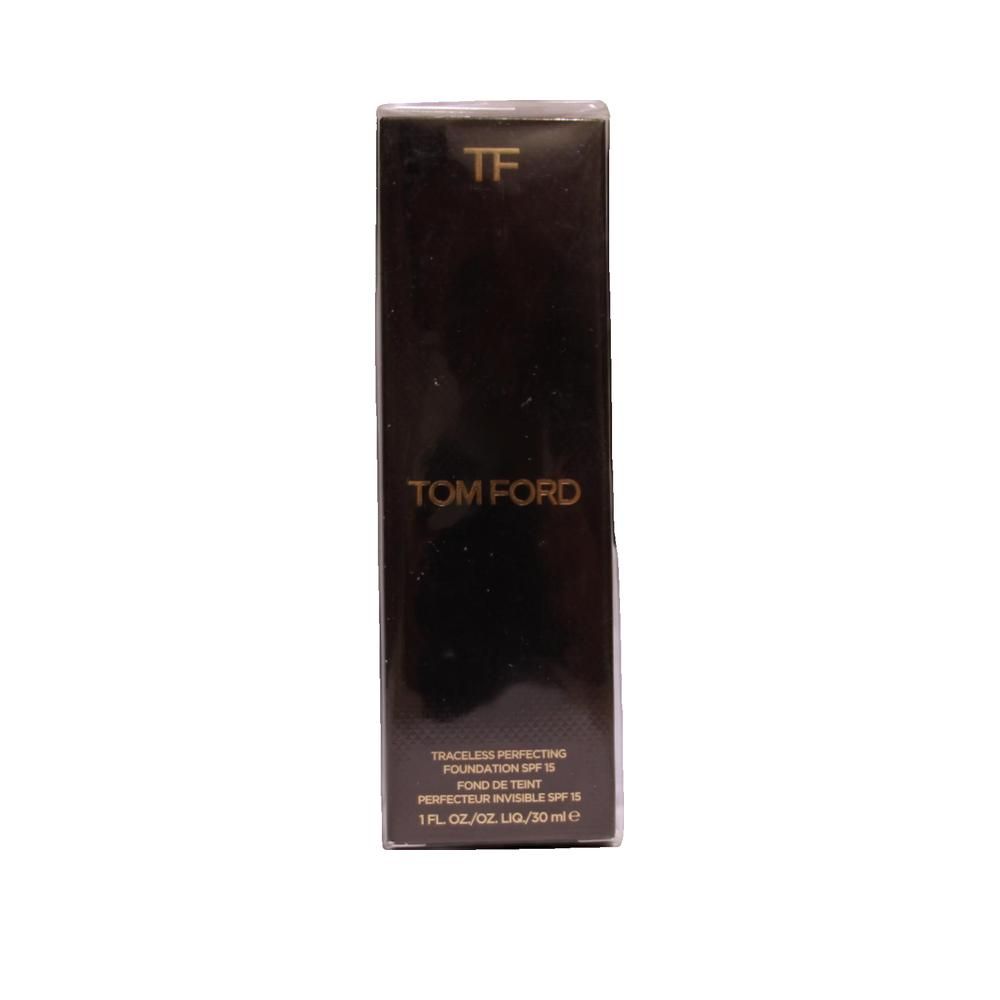 Boîte noire avec texte doré. "TF" en haut, "TOM FORD" en dessous. Texte: Traceless Perfecting Foundation SPF 15. 1 FL.OZ./OZ.LIQ/30 ml e