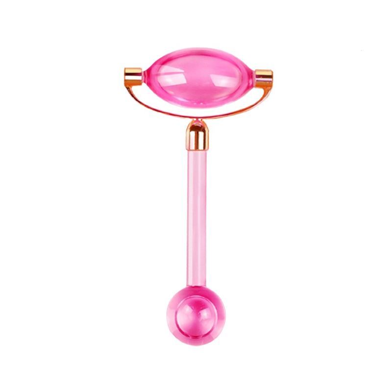 Roze gezichtsroller. Ovale kop, goudkleurige houder, cilindrische handgreep en ronde kop aan het uiteinde.
