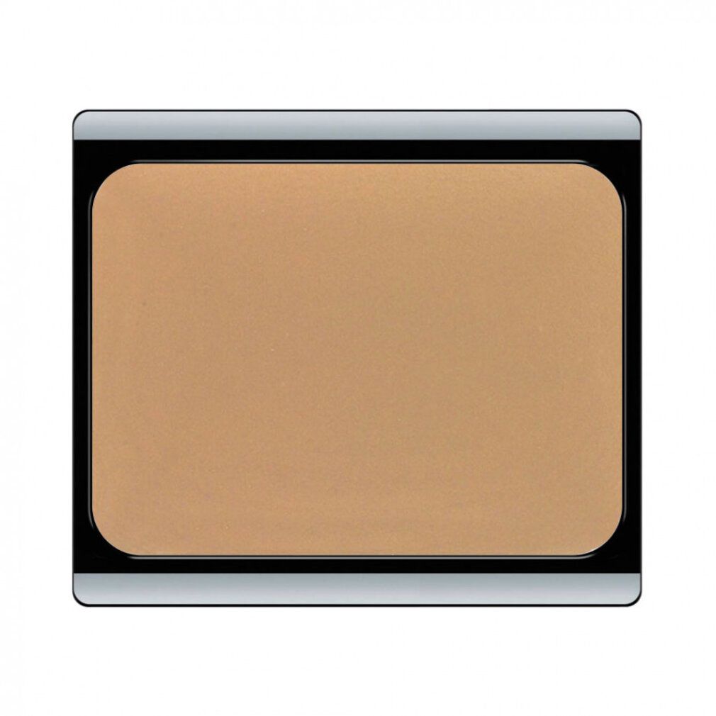Crème de camouflage beige dans un boîtier rectangulaire à bord noir. Couvercle à bord argenté.