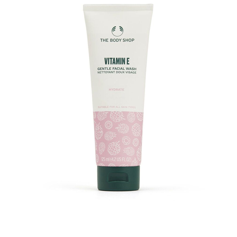 Tube The Body Shop Vitamin E Gentle Facial Wash, 125 ml. Tube blanche avec motif rose et bouchon vert.