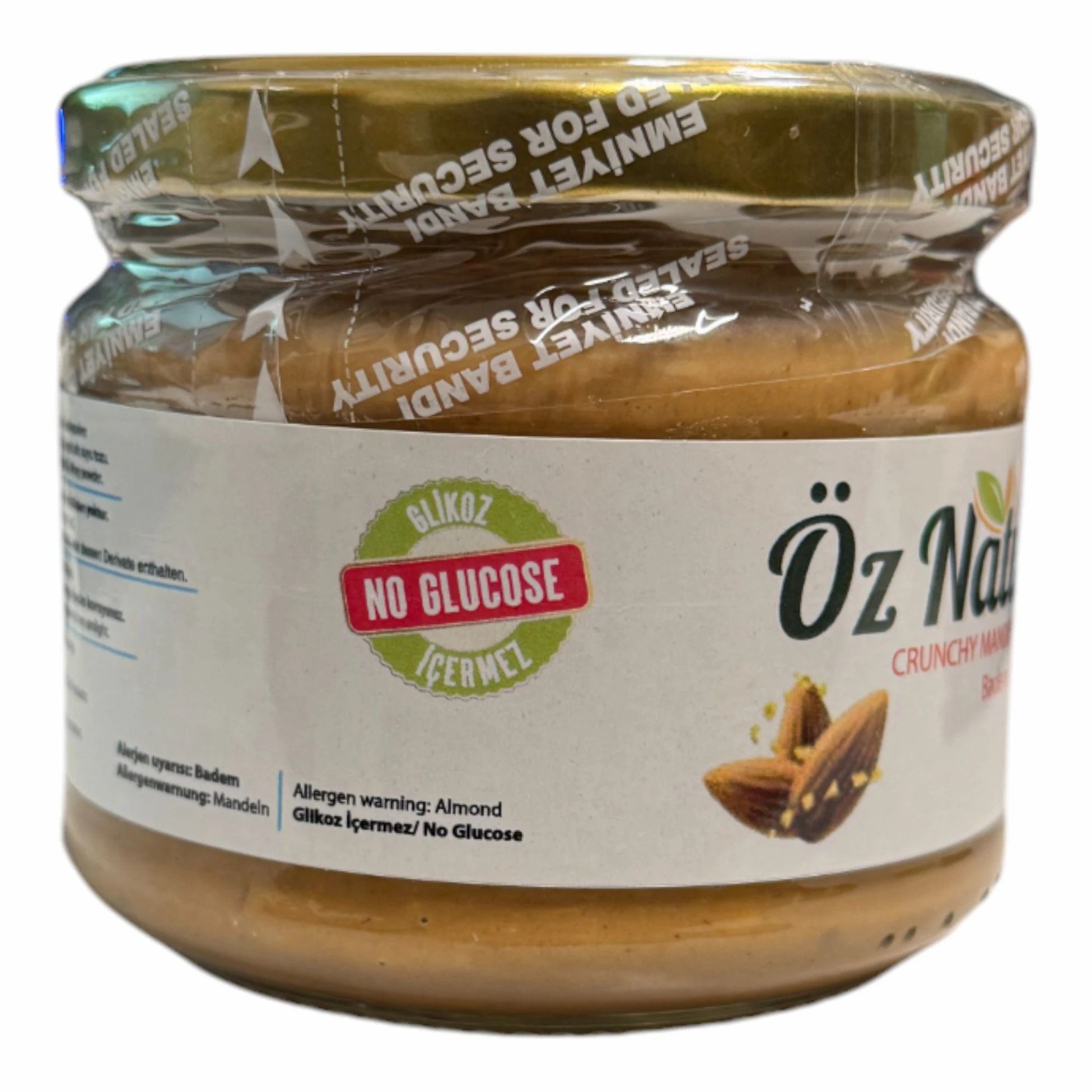 Pot amandelpasta. Opschrift: Öz Natur, Crunchy Mandelpaste, Badem Ezmesi. Zegel: Emniyet Bandi. Sticker: No Glucose.