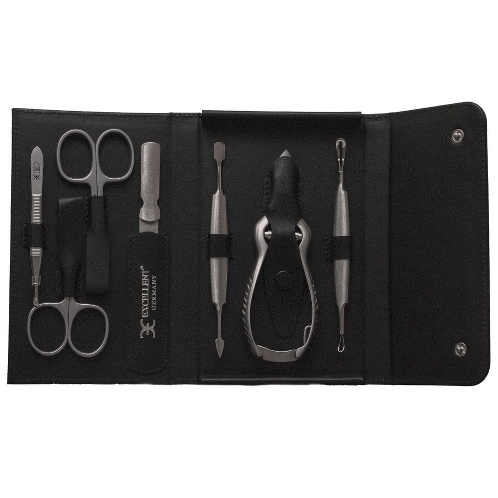 Étui manucure 7 pièces en cuir noir avec ciseaux, coupe-ongles et pince à épiler.