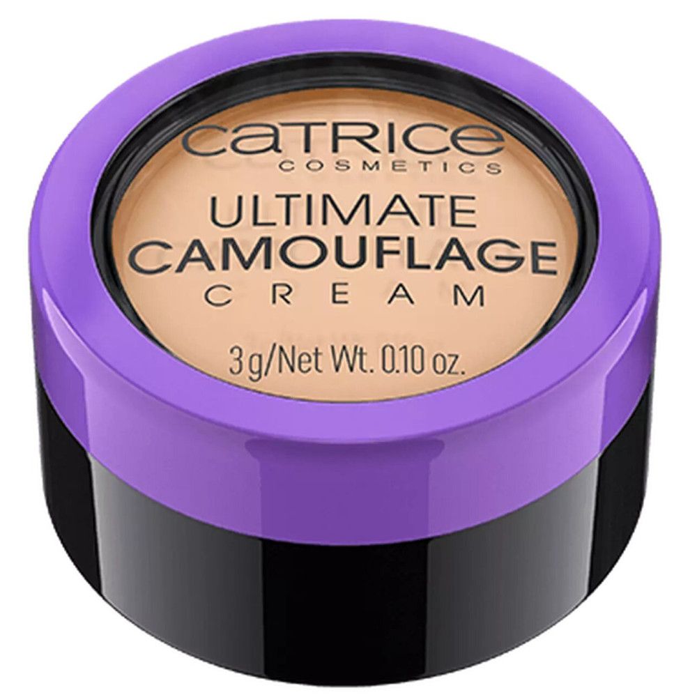 Correcteur en pot noir avec couvercle violet. Inscription: Catrice Ultimate Camouflage Cream. Contenu: 3g/Net Wt. 0.10 oz.