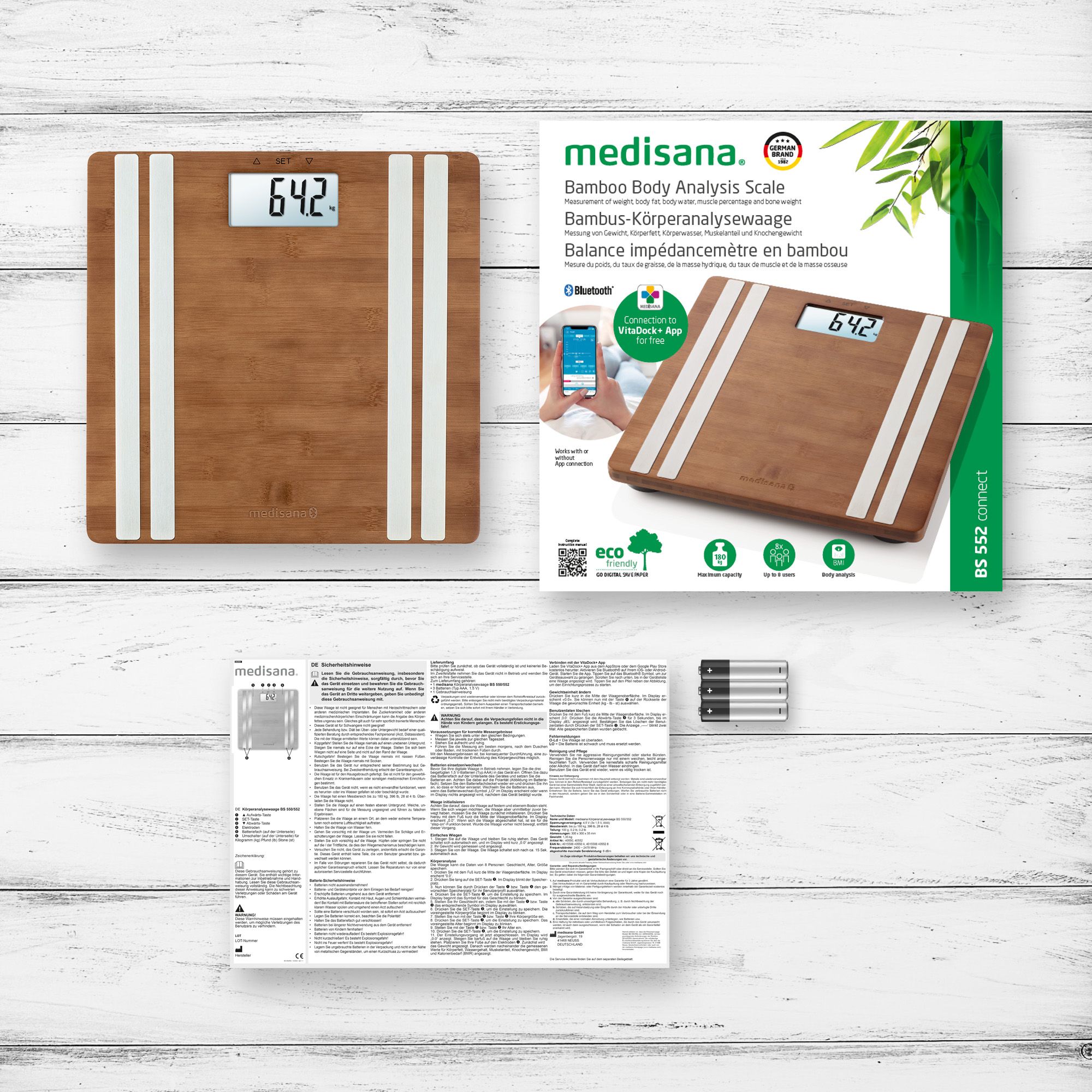 Verpakking van een bamboe lichaamsanalyse weegschaal met weegschaal, app-display en handleiding.