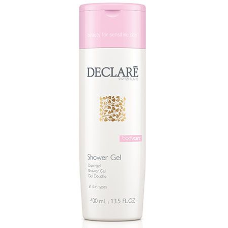 Gel douche blanc avec bouchon rose. Inscription Declare, texte 'Shower Gel' et 'bodycare'.