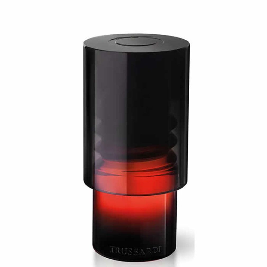 Flacon noir dégradé rouge. Le flacon a une forme cylindrique avec un bouchon noir.