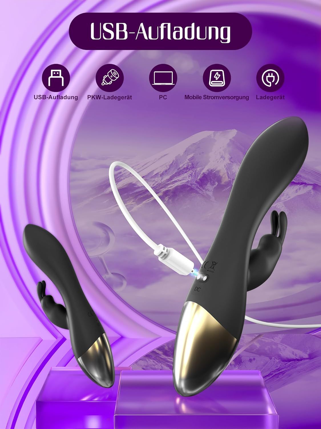 Vibrateur G-spot noir avec extrémité dorée, posé sur un tissu violet.